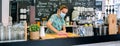 Waitress disinfecting bar counter due to coronavirus