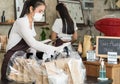 Waitress with face mask prepare order for curbside pick up and takeout