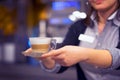 Waitress gives cappuccino to the client