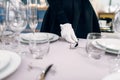 Waitress in gloves puts the knife, table setting