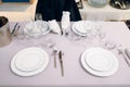 Waitress in gloves puts the knife, table setting