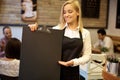 Waitress holding blackboard