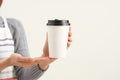 A waitress holding and serving a paper cup of hot coffee in cafe Royalty Free Stock Photo