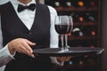 Waitress holding a tray with glasses of red wine Royalty Free Stock Photo