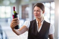 Waitress holding a wine bottle Royalty Free Stock Photo