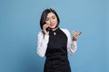 Waitress managing conversation on phone Royalty Free Stock Photo