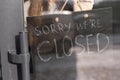 A waitress in a medical mask with closed sign