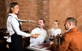 Waitress placing order in front of guests Royalty Free Stock Photo