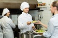 Waitress with plates at kitchen Royalty Free Stock Photo