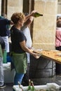 Waitress pouring Cider in a traditional event in San Sebastian.