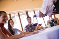 Waitress pouring red wine in wine glass on table Royalty Free Stock Photo