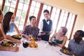 Waitress pouring red wine in wine glass on table Royalty Free Stock Photo