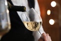 Waitress pouring wine into glass in restaurant, Royalty Free Stock Photo