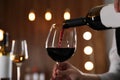 Waitress pouring wine into glass in restaurant Royalty Free Stock Photo