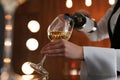 Waitress pouring wine into glass in restaurant Royalty Free Stock Photo