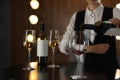 Waitress pouring wine into glass in restaurant Royalty Free Stock Photo