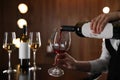 Waitress pouring wine into glass in restaurant Royalty Free Stock Photo