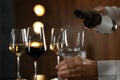 Waitress pouring wine into glass in restaurant Royalty Free Stock Photo