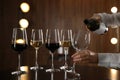 Waitress pouring wine into glass in restaurant Royalty Free Stock Photo