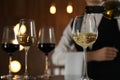 Waitress pouring wine into glass in restaurant Royalty Free Stock Photo