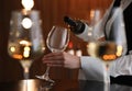 Waitress pouring wine into glass in restaurant Royalty Free Stock Photo