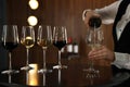 Waitress pouring wine into glass in restaurant Royalty Free Stock Photo