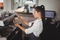 Waitress preparing espresso at restaurant