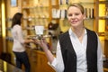 Waitress presenting cup of coffee or tea Royalty Free Stock Photo