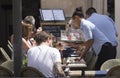 Waitress serving beverages at touristic terrace bar detail