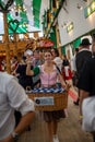 Waitress selling brezels in beer tent