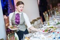 Waitress serving banquet table