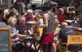 Waitress serving beverages at touristic sunny terrace bar