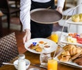 Waitress serving breakfast at a restaurant Royalty Free Stock Photo