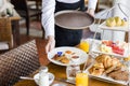 Waitress serving breakfast at a restaurant Royalty Free Stock Photo