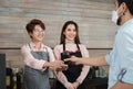 Waitress serving coffee to customer at counter bar Royalty Free Stock Photo