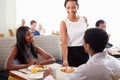 Waitress Serving Couple Breakfast In Hotel Restaurant