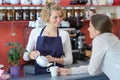 waitress serving cup coffee to customer in cafe Royalty Free Stock Photo