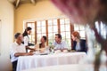 Waitress serving food on the table Royalty Free Stock Photo