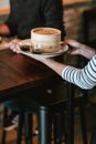 Waitress serving a man at a restaurant table Royalty Free Stock Photo