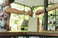 Waitress serving takeaway food to customer in small business social distance conceptual. Royalty Free Stock Photo