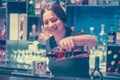 Girl bartender pours wine into a wine glass Royalty Free Stock Photo