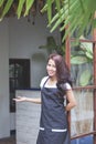 Waitress standing at the front of a cafe inviting people to come Royalty Free Stock Photo