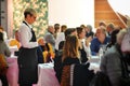 Waitress takes orders at the diners` table of crowded restaurant Royalty Free Stock Photo