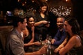 Waitress Takes Payment For Restaurant Bill On Digital Tablet Royalty Free Stock Photo