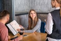 Waitress taking and order from young couple in restaurant Royalty Free Stock Photo