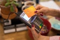 Waitress taking payment from credit card wirelessly on POS terminal Royalty Free Stock Photo