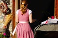 Waitress in traditional Austrian dress entering restaurant