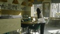 Waitress in uniform sets the tables in cafe