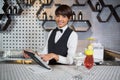 Waitress using digital tablet in bar counter Royalty Free Stock Photo