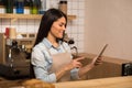 Waitress using digital tablet in cafe Royalty Free Stock Photo